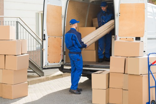 Removal team handling furniture in Surrey Quays apartment move