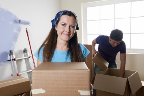 Local moving team handling boxes near Surrey Quays apartments