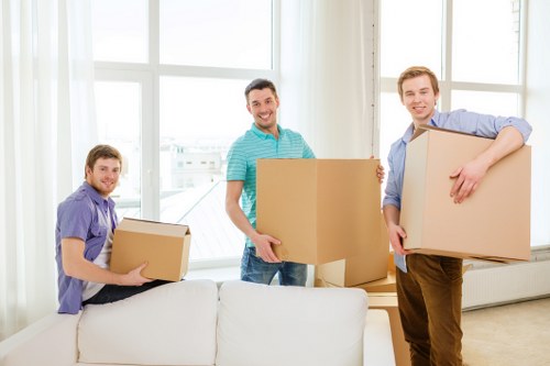 House removal crew handling furniture from a Surrey Quays apartment